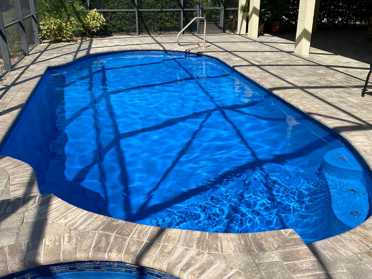 A finished TruBlue Pools resurfacing and maintenance project on a screened lanai